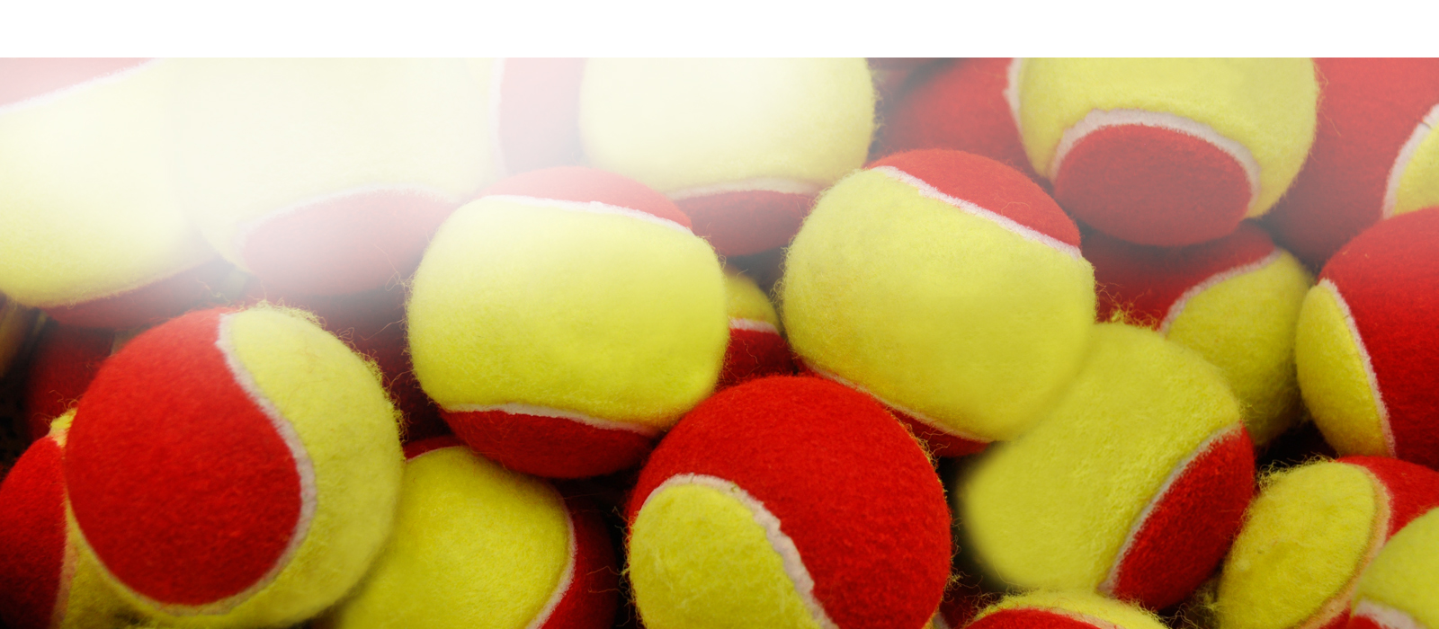 yellow and red tennis balls stacked on top of each other