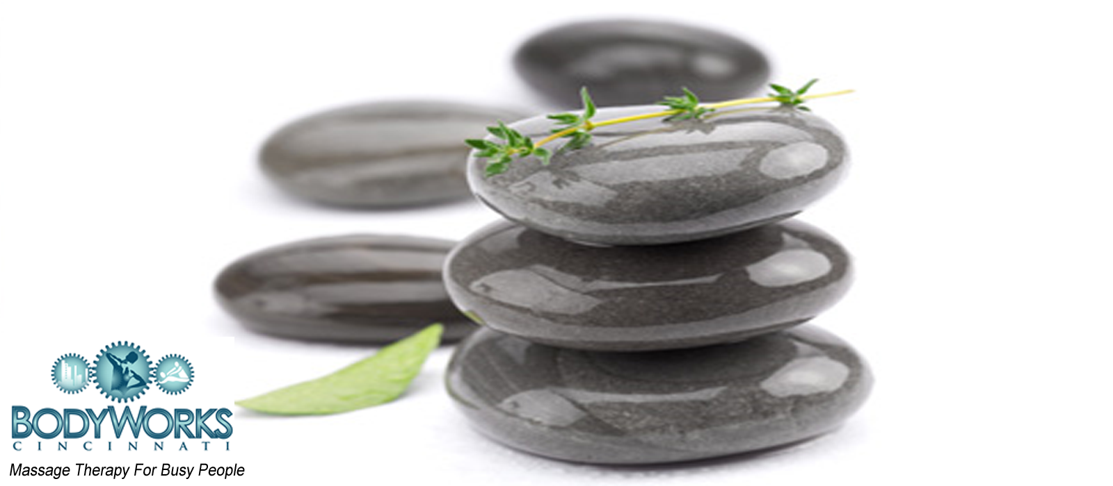stacked massage stones with herbs
