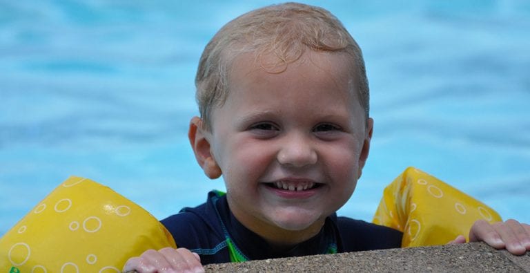 toddler with arm floaties at Cincinnati pool