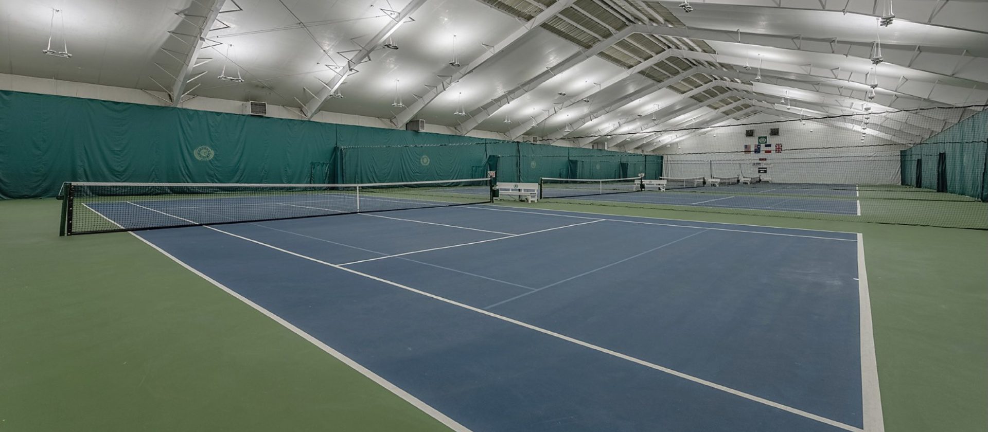 a close up of an indoor tennis court at the club at harpers point in cincinnati