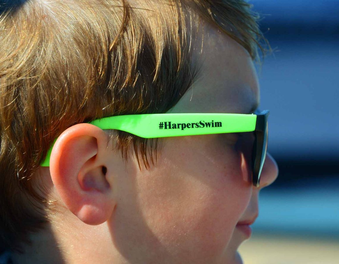 a kid swimmer with sunglasses at the club at harpers point aquatic club near me